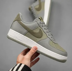 Cómo saber si unos tenis son originales Tenis Nike Air Force 1 original sostenido en la mano para mostrar sus detalles.